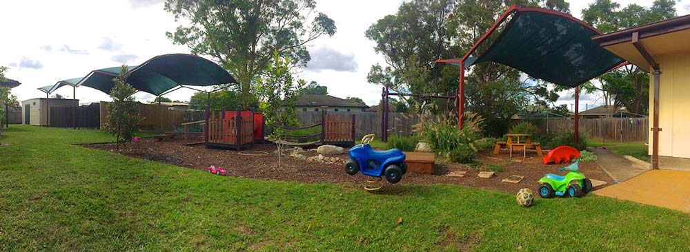 A photo of a backyard area with children's play area