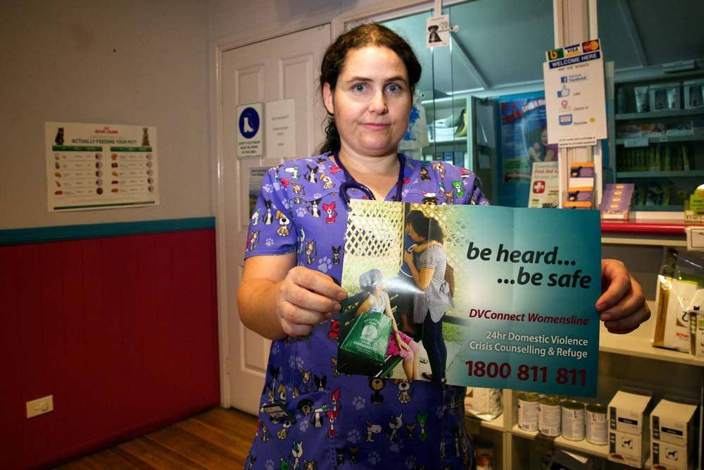 A photo of Dr Catherine Tiplady holding up a poster