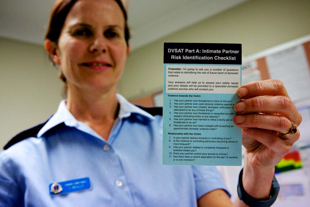 A close-up photo of a flyer being held by a policewoman