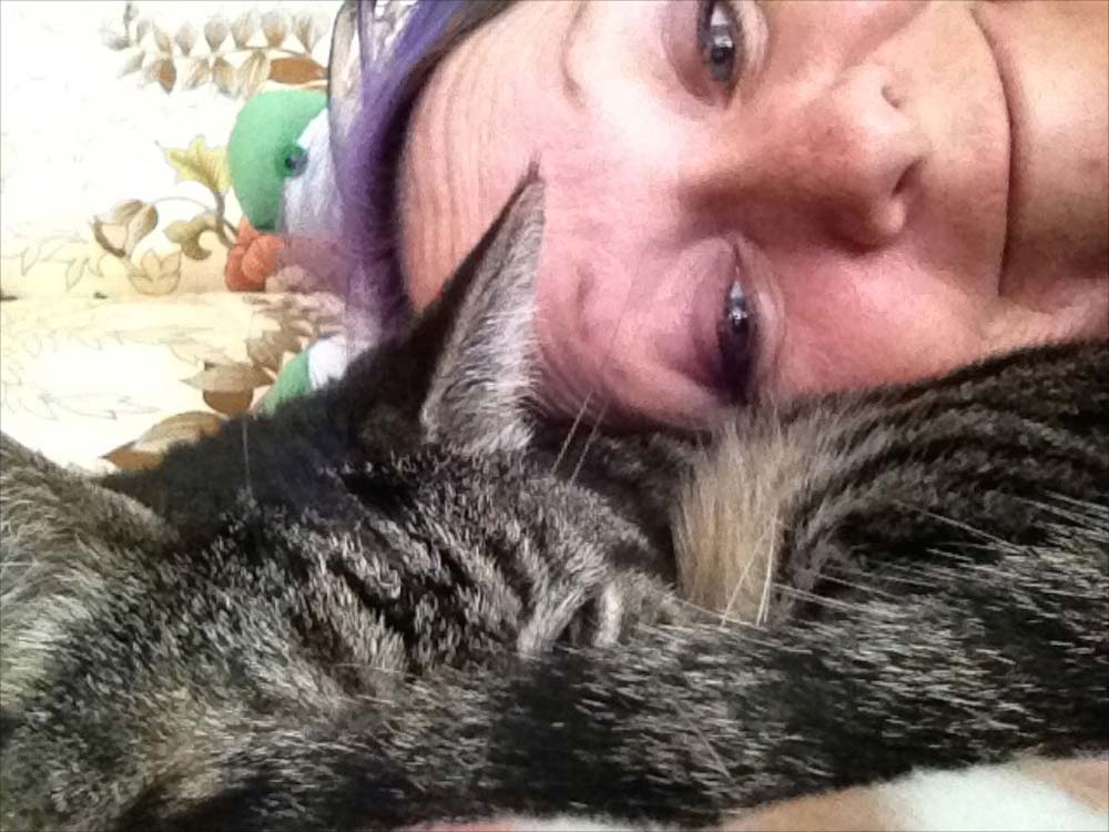 A closeup photo of a woman and a cat